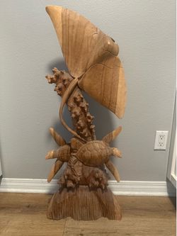 Hand carved  Wood statue with turtles and ray.