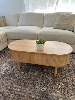 Beautiful EAG fluted lift-top coffee table in a natural wood finish.