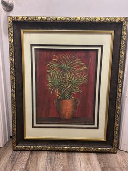 framed painting depicting a potted plant.