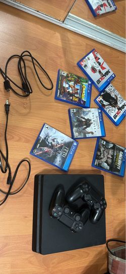 PlayStation 4 with two controllers and multiple games