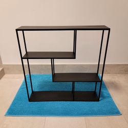 Black metal wall-mounted shelf. Measures 24" x 24" x 5" / 33182.