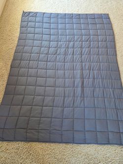 * Gray weighted sleeping bed blanket.