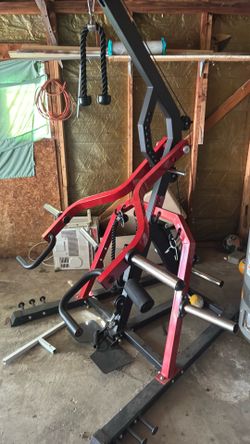 a plate-loaded leverage home gym with a lat pulldown/high pulley, low pulley, and press/row arms.