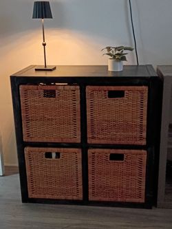 4 cubbies cabinet. It's painted in a black wash. Four baskets included (check Ikea for prices) $25 each!  😆