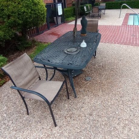 Pool Chairs And Tables With Umbrellas 