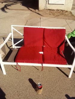White Metal Outdoor Loveseat with Red Cushions