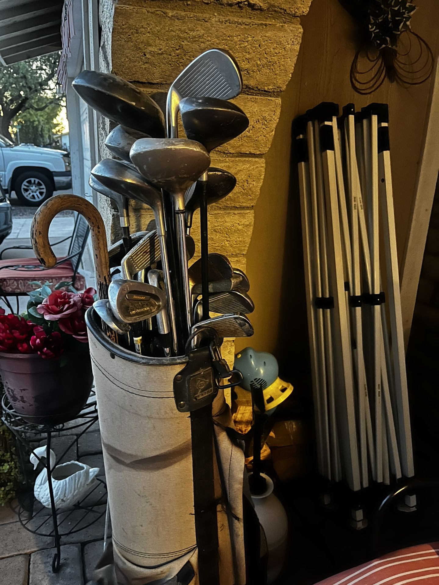 Antique golf clubs, golf balls, and bag