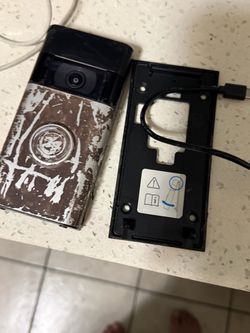 Ring Video Doorbell with Mounting Bracket it was painted brown to camouflage it, but it works