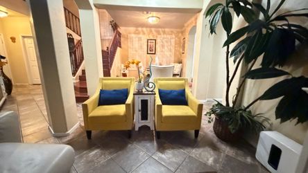 Beautiful Carocc accent chairs witnailheads and solid wood yellow lines