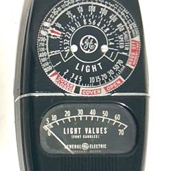  General Electric (GE) exposure meter, likely a model from the DW series such as the DW-58Y5 or DW-48. These vintage analog meters were produced from 