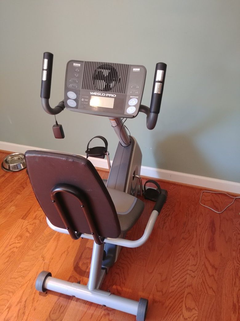 Stationary bicycle with adjustable seat and electric built in fam