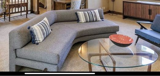 curved gray sectional sofa and glass table