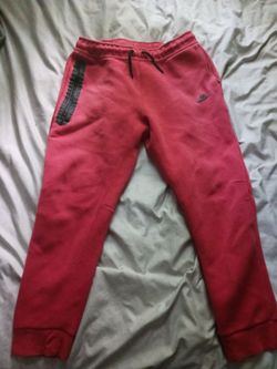 Red Nike tech sweatpants