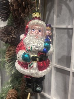 Vintage 1999 BK Christmas ornament Santa with a bag of toys, his right boot tip is broken. Please see all photos.