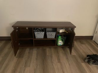 Dark wood (not real wood) tv stand.