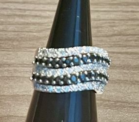 Elegant multi-row ring featuring alternating black and white crystals. The black and white colorway adds classic contrast to any outfit. Designed for