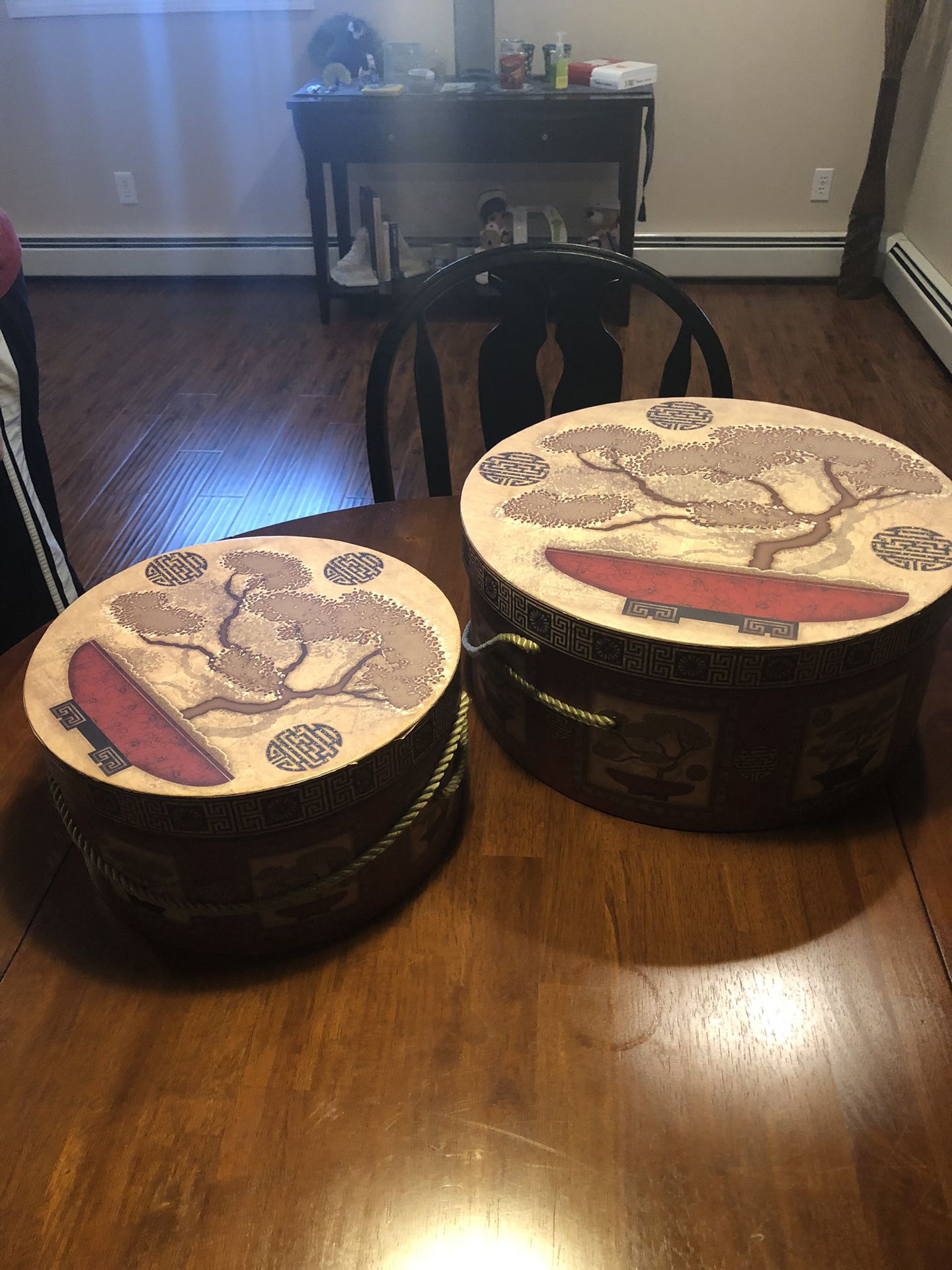 Two Red And Cream Colored Hat Boxes