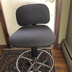 Art studio chair. Grey fabric steel frame. On wheels  adjustable seat excellent condition. Local Pick up. $65.00