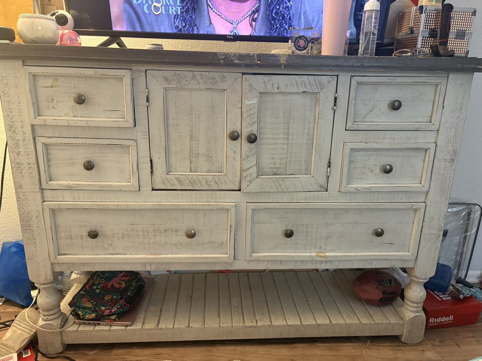 This is a rustic or farmhouse-style dresser or chest of drawers.  