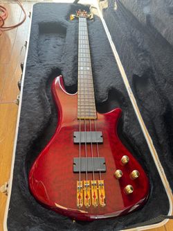Schecter Stiletto Elite 4-String Electric Bass Guitar in a black-cherry quilted maple finish with gold hardware