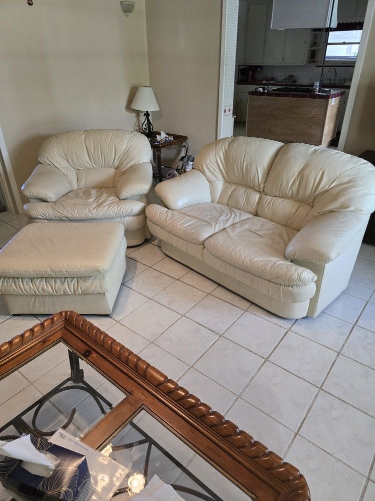 Cream Color Leather Love Seat And Chair And Ottoman.