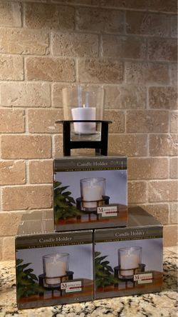 Three iron and glass candleholders.