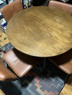 Round Dining Room Table And Four Synthetic Leather Chairs