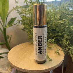 Amber Perfume Oil – Earthy, Warm, Fresh, and Mystical 10ml glass roll-on bottle  Indulge in the grounding warmth of Amber, a natural fragrance oil wit