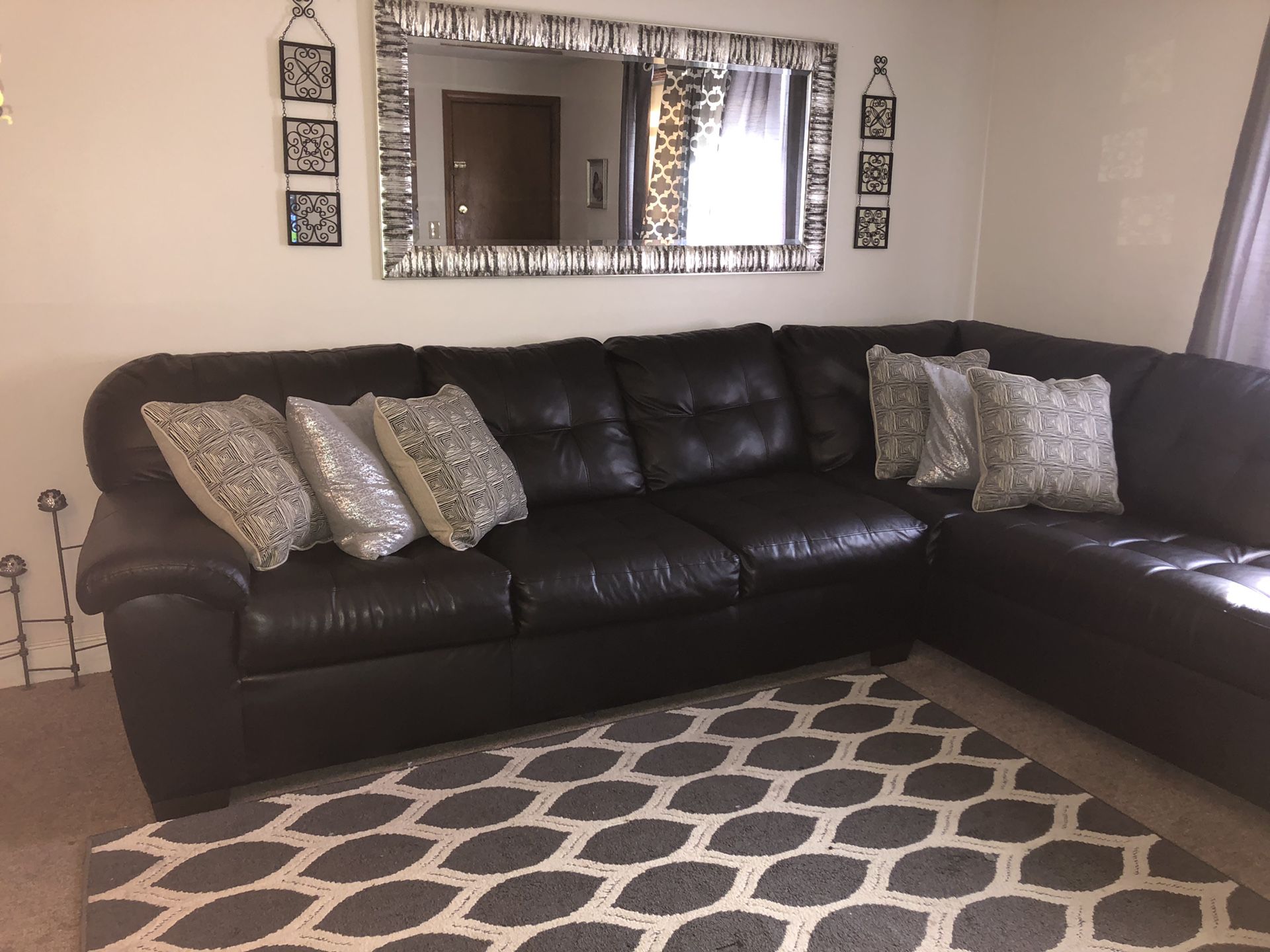 Sectional black cauch sofa 1 and half year