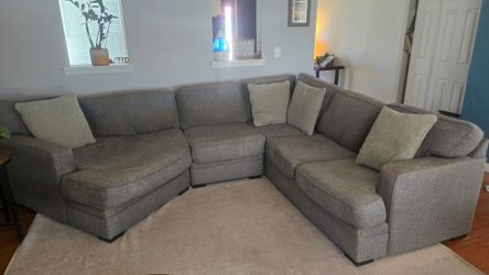 Gray sectional with pillows