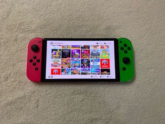 NINTENDO SWITCH OLED + 125 SWITCH GAMES