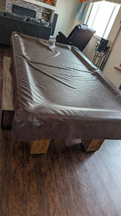 Pool table with balls, sticks, and table tennis