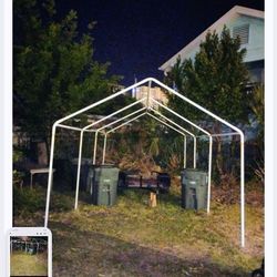 Carport with metal pipes and canopy