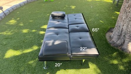 The leather sofa bed also has a spot for your drinks and food.