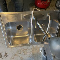 Sink, Gas Stove And Range Hood.