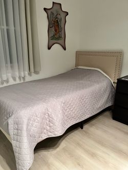 Two matching twin bed frame with twin mattress.