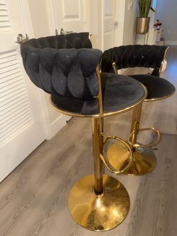 2 black tufted barstool chairs