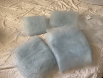 Four light blue long pieces of tulle for crafts project