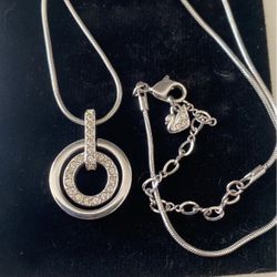 Circle Pendant with small diamonds.