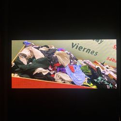 Table Full Of Mixed New Stuff And Clothes 