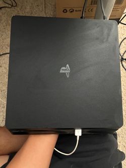 PS4 with controller and games