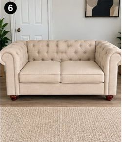 cream-colored Couch, upholstered Chesterfield-style loveseat with button tufting and rolled arms