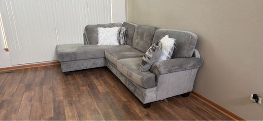Gray Sectional and Round Swivel Chair