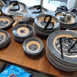 The dishes shown in the image are a set of Currier & Ives dinner set from Royal China Company.  This characteristic blue and white dishes with Currier