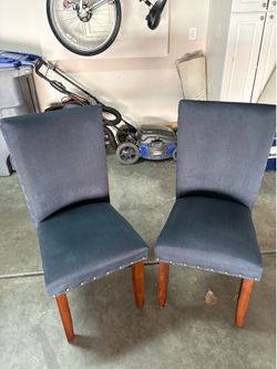 4 Dark Blue dining chairs with nailhead trim.