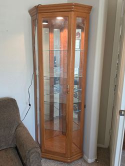 Corner Curio Cabinet. Lighted with Glass Door and Shelving