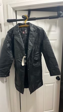 A vintage double-breasted long black genuine leather trench coat.
