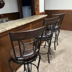 Three swivel bar stools