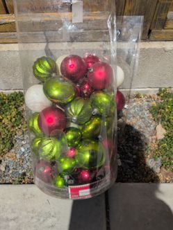 Red white and green ornaments and tree topper