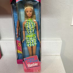1998 Mattel Pretty In Plaid Barbie doll with blonde hair and a green and blue daisy-patterned dress.  The doll features bendable limbs and long, strai